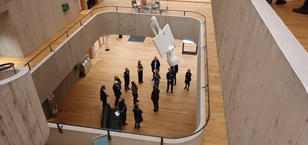 Blick von oben in das Atrium des Swiss TPH mit der Besuchergruppe