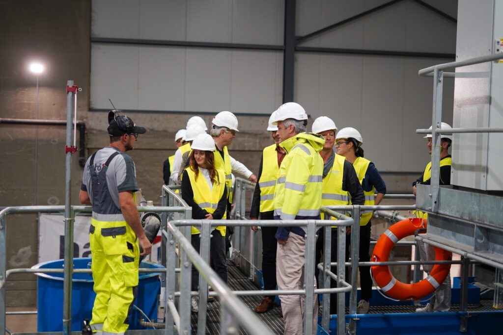 Ein Mitarbeiter der habö AG erklärt der Besuchergruppe die Materialaufbereitung